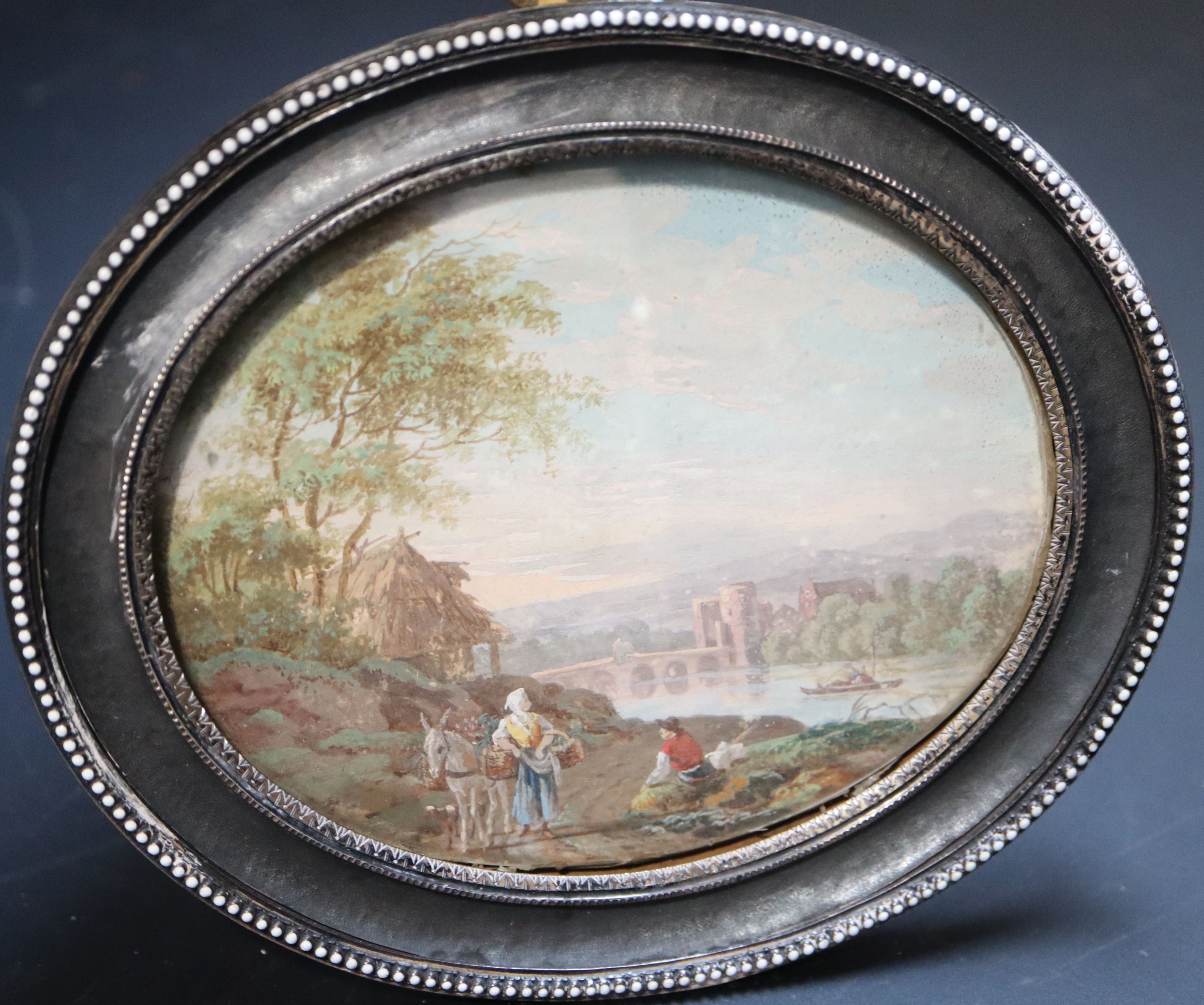 Style of Zuccarelli, Travellers in an Italianate landscape 9 x 11cm white enamel beaded decoration and gilt metal back overall 12.5 x 1